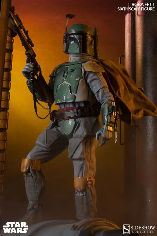 Boba Fett sixth-scale figure standing in an industrial setting with a blaster rifle raised, brown cape flowing, and orange lighting behind him