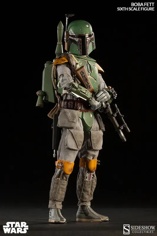 Full-body Boba Fett sixth-scale figure standing against a black background with a blaster rifle, jetpack, gray flight suit, yellow knee pads, and weathered green armor