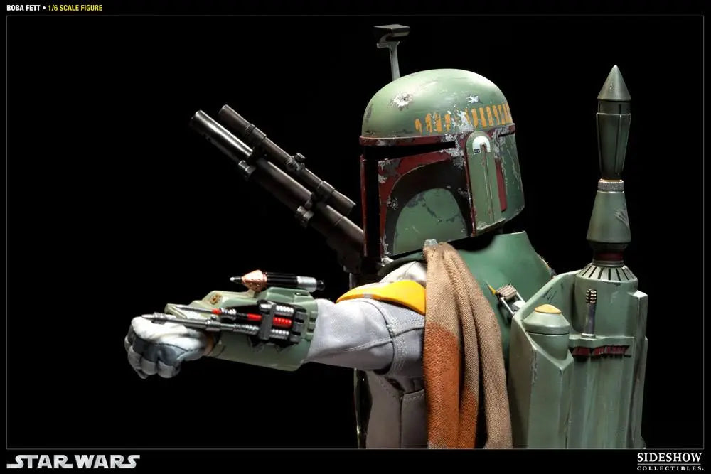 Boba Fett sixth-scale figure in green and red weathered armor, aiming a wrist-mounted gauntlet weapon with a blaster rifle and jetpack visible against a black background.