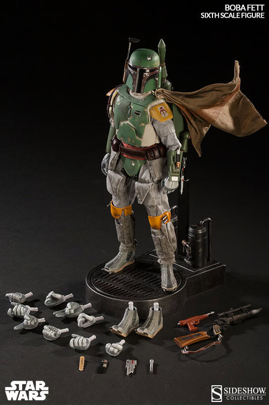 Boba Fett sixth-scale figure on a display stand with interchangeable hands, weapons, boots, and accessories arranged around the base.