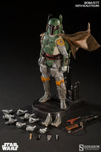 Boba Fett sixth-scale figure on a display stand with interchangeable hands, weapons, boots, and accessories arranged around the base.